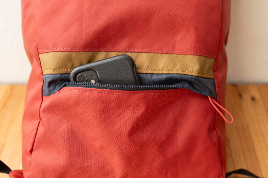 Smart phone sticking out of front pocket on handlebar bag